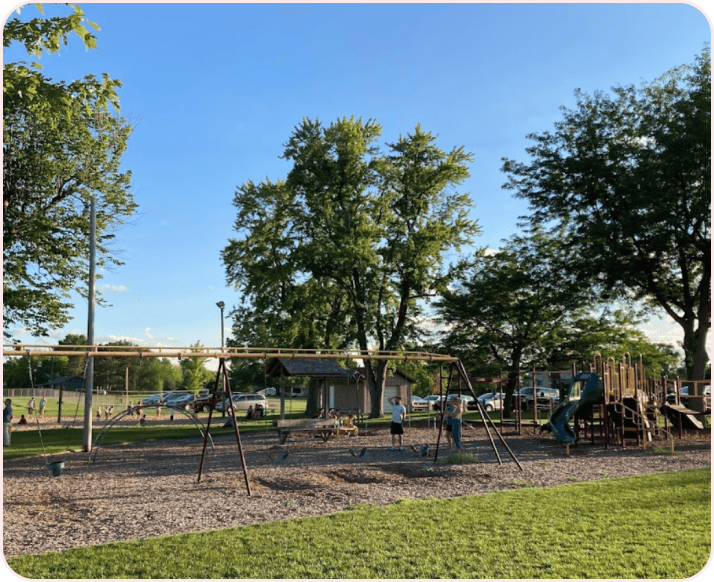 A village park playground on a summer evening