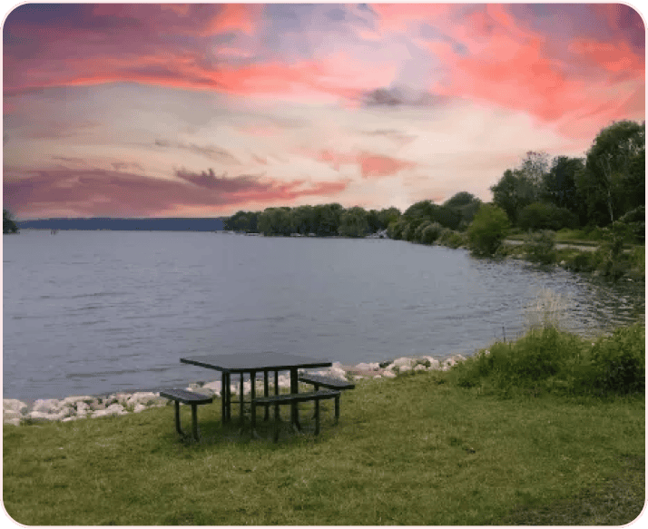 A picnic table overlooking the lake at sunset